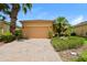 Charming single Gathering home featuring desert landscaping and a brick paver driveway at 1405 Harbor Ridge Dr, Kissimmee, FL 34759