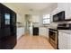 Well-lit kitchen boasts tile flooring, stainless steel appliances and granite countertops at 1405 Harbor Ridge Dr, Kissimmee, FL 34759