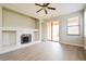 Bright living room featuring a fireplace, wood floors, ceiling fan and large sliding glass doors at 1405 Harbor Ridge Dr, Kissimmee, FL 34759