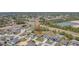 Aerial view of the property with the location arrow, situated in a residential neighborhood with a pond nearby at 329 W Aster Ct, Poinciana, FL 34759