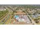 Stunning aerial view of community amenities: pool, baseball field, recreational areas, ample parking, and convenient access at 329 W Aster Ct, Poinciana, FL 34759