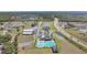 Aerial view of community amenities featuring a pool, clubhouse, parking and green spaces at 329 W Aster Ct, Poinciana, FL 34759