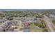 Aerial shot of the property in a community, revealing a generous backyard with white vinyl fencing at 329 W Aster Ct, Poinciana, FL 34759