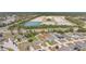 Aerial view of a neighborhood with well-maintained homes and a large, green space. Arrow pointing to the home's location at 329 W Aster Ct, Poinciana, FL 34759