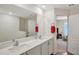 Bright bathroom with double vanity, large mirror, and neutral walls at 329 W Aster Ct, Poinciana, FL 34759