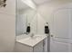Clean bathroom with modern vanity, mirror, and a convenient towel rack, enhancing its functionality at 329 W Aster Ct, Poinciana, FL 34759