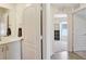 Bright bathroom featuring double door with hardwood floors leading into a bedroom at 329 W Aster Ct, Poinciana, FL 34759