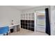 Bright bedroom with shelving units and a work desk, providing ample storage and workspace at 329 W Aster Ct, Poinciana, FL 34759