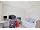 Functional bedroom with a built-in daybed, work desk, and a comfortable office chair at 329 W Aster Ct, Poinciana, FL 34759