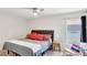 Bedroom featuring a ceiling fan, neutral walls, and a patterned bedspread at 329 W Aster Ct, Poinciana, FL 34759