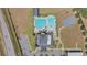 Overhead aerial view of a community pool and recreational area featuring a play area and bathhouse at 329 W Aster Ct, Poinciana, FL 34759