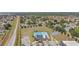 Aerial view of a community pool and recreational area with lush landscaping and ample parking at 329 W Aster Ct, Poinciana, FL 34759