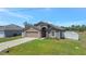 Charming single-Gathering home with a well-manicured lawn, attached garage, and inviting entryway at 329 W Aster Ct, Poinciana, FL 34759