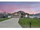 Charming single-story home with a well-manicured lawn, concrete driveway, and an attached two-car garage at 329 W Aster Ct, Poinciana, FL 34759