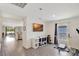 Bright home gym with grey wood-look floors, neutral walls, and a view into the living room at 329 W Aster Ct, Poinciana, FL 34759