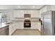 Bright kitchen with granite countertops and stainless steel appliances at 329 W Aster Ct, Poinciana, FL 34759