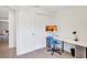 Bright office featuring a spacious desk, blue office chair, and soothing wall art for a productive workspace at 329 W Aster Ct, Poinciana, FL 34759