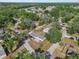 An aerial shot of a charming white house nestled among lush trees in a tranquil neighborhood at 4795 Myrtle View W Dr, Mulberry, FL 33860
