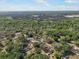 Panoramic aerial view of a community surrounded by lush green trees and a solar farm at 4795 Myrtle View W Dr, Mulberry, FL 33860