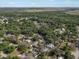 Wide angle drone shot of a rural neighborhood surrounded by mature trees and foliage at 4795 Myrtle View W Dr, Mulberry, FL 33860