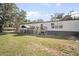 View of the back of the home with a small deck and fenced in area at 4795 Myrtle View W Dr, Mulberry, FL 33860