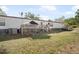 Backyard view of home with dog kennel and small deck at 4795 Myrtle View W Dr, Mulberry, FL 33860