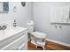 Bathroom with white vanity, wood floor, mirror and comfort height toilet with training step at 4795 Myrtle View W Dr, Mulberry, FL 33860