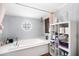 Relaxing bathroom features a soaking tub, a unique window, and convenient built-in storage at 4795 Myrtle View W Dr, Mulberry, FL 33860
