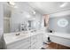 Spacious bathroom with double vanity, a soaking tub, and a separate shower area at 4795 Myrtle View W Dr, Mulberry, FL 33860