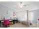 This bedroom offers a canopy style bed, modern desk, and bright unicorn artwork at 4795 Myrtle View W Dr, Mulberry, FL 33860