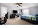 bedroom with ceiling fan, bed with blue quilt, and TV on entertainment center at 4795 Myrtle View W Dr, Mulberry, FL 33860