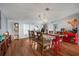 Bright dining room featuring a large wood table, red stools, and decor, an open view to the kitchen at 4795 Myrtle View W Dr, Mulberry, FL 33860