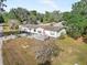 Charming single-story home featuring a covered porch, red door, driveway, and lawn at 4795 Myrtle View W Dr, Mulberry, FL 33860