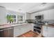 Bright kitchen features stainless steel appliances, white cabinets, and granite countertops at 4795 Myrtle View W Dr, Mulberry, FL 33860