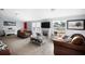 Comfortable living room features a white fireplace, leather furniture, and bright natural light at 4795 Myrtle View W Dr, Mulberry, FL 33860