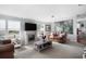 Comfortable living room features a white fireplace, leather furniture, and bright natural light at 4795 Myrtle View W Dr, Mulberry, FL 33860