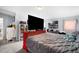 Cozy primary bedroom features an attached dividing wall, with soft carpet, and a modern wall art at 4795 Myrtle View W Dr, Mulberry, FL 33860