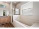 Bathroom features a large tub, separate shower, and a vanity with a mirror at 541 Willet Cir, Auburndale, FL 33823