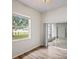Bright bedroom with wood floors, large window and sliding glass door to a patio at 541 Willet Cir, Auburndale, FL 33823