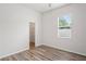 Clean and bright bedroom with wood floors and a walk-in closet, offering comfort and convenience at 541 Willet Cir, Auburndale, FL 33823