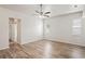Large bedroom featuring a ceiling fan, light wood-look floors, and natural light at 541 Willet Cir, Auburndale, FL 33823