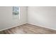 A bedroom features wood floors, a window and fresh, neutral paint at 541 Willet Cir, Auburndale, FL 33823