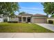 Charming single-story home with a well-manicured lawn and a two-car garage at 541 Willet Cir, Auburndale, FL 33823