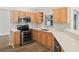 Updated kitchen with light wood cabinets, stainless steel appliances, and stylish countertops at 541 Willet Cir, Auburndale, FL 33823