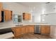 Well-lit kitchen with light wood cabinets, modern appliances, and white countertops at 541 Willet Cir, Auburndale, FL 33823