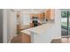 Well-equipped kitchen featuring modern appliances, light wood cabinetry, and sleek countertops at 541 Willet Cir, Auburndale, FL 33823