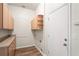 Laundry room features plenty of storage with a sink, counter, and wood cabinets at 541 Willet Cir, Auburndale, FL 33823