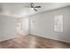 Spacious main bedroom with wood floors, ceiling fan, and ensuite bathroom featuring a large tub at 541 Willet Cir, Auburndale, FL 33823