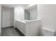 Bright bathroom features a single sink vanity and wood look floors at 603 Bay Leaf Dr, Poinciana, FL 34759