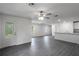 Living room featuring gray wood floors, white walls, recessed lighting, ceiling fan, and an abundance of natural light at 603 Bay Leaf Dr, Poinciana, FL 34759